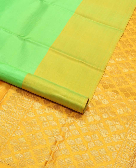 Light green kancheepuram silk sare with contrast floral design border & argyle design pallu