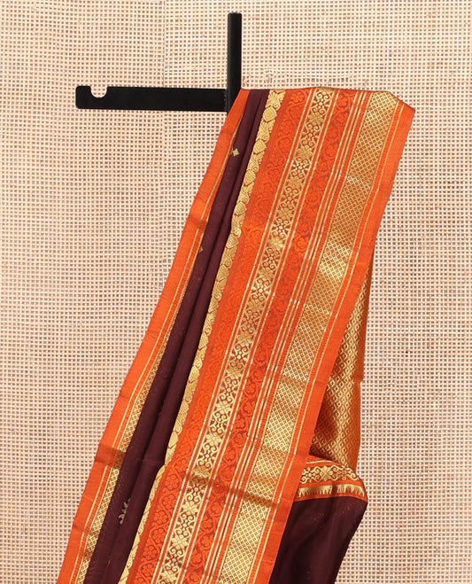 Brown Venkatagiri Silk Saree, Spotlighted with Zari Buttas All Over Its Body, Complemented by a Contrast Border of Temple, Floral, and Peacock-Eye Designs, Pallu of Peacock Eye Designs, and Paired with a Contrast Blouse