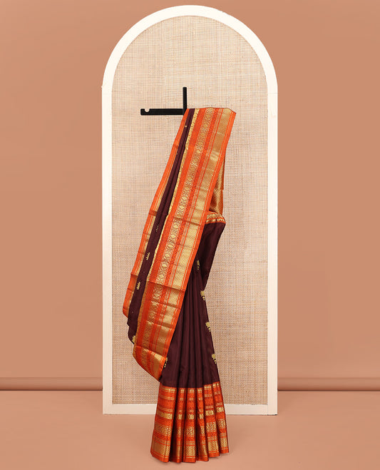 Brown Venkatagiri Silk Saree, Spotlighted with Zari Buttas All Over Its Body, Complemented by a Contrast Border of Temple, Floral, and Peacock-Eye Designs, Pallu of Peacock Eye Designs, and Paired with a Contrast Blouse
