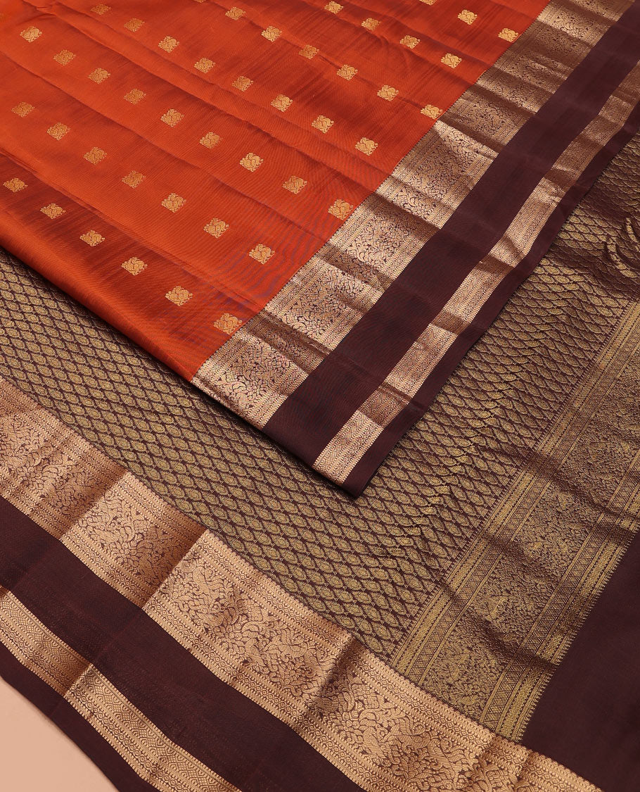 Rust Orange Vasundhara Lite-Silk Mix Saree Showcasing Mayil Buttas, Complemented with a Contrast Rettai Pettu Border Featuring Muthu, Diamond, and Mayil Designs, Adorned with Jaal Pallu, and a Contrast Blouse