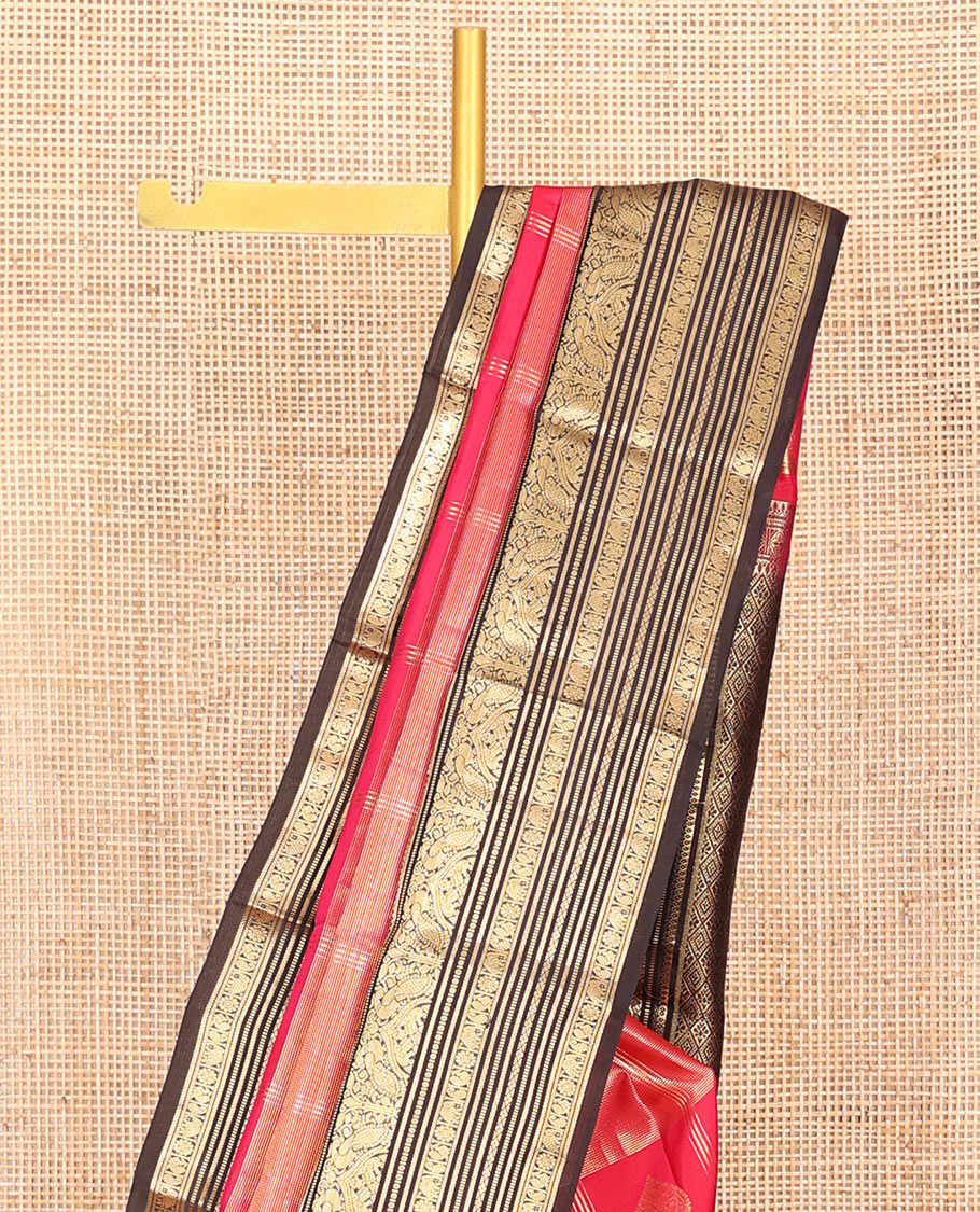 Red Vasundhara Silk Saree, Accentuated with Zari Buttas and Zari Stripes All Over Its Body, Complemented by a Contrast Border of Thilakam, Banaras, Muthu, Yaanai, Manga, and Mayil Designs, Zari Elevated Jaal Pallu, and Paired with a Contrast Blouse