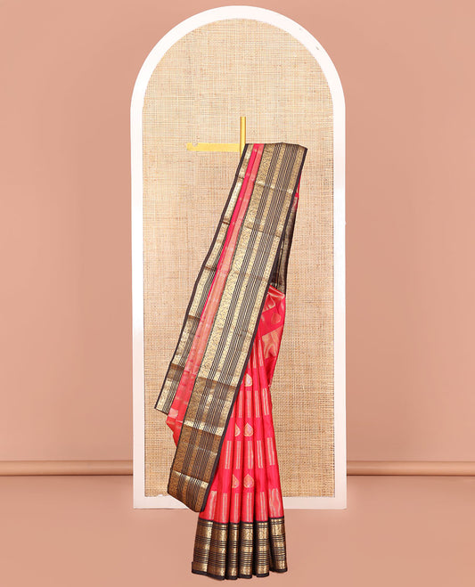 Red Vasundhara Silk Saree, Accentuated with Zari Buttas and Zari Stripes All Over Its Body, Complemented by a Contrast Border of Thilakam, Banaras, Muthu, Yaanai, Manga, and Mayil Designs, Zari Elevated Jaal Pallu, and Paired with a Contrast Blouse