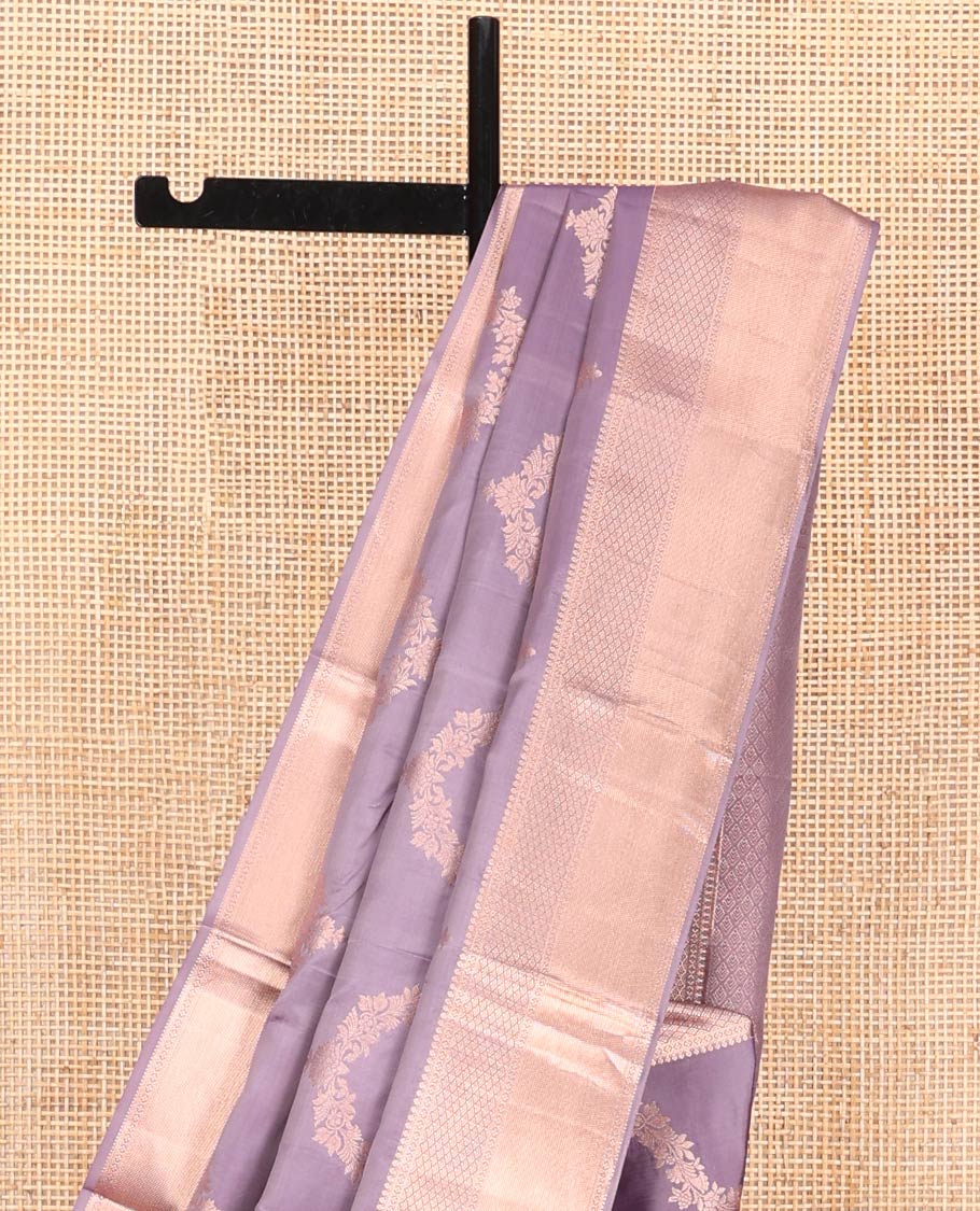 Lavender Vasundhara Silk Saree, Embellished with Floral Jaal Jacquard on Its Body, Highlighted by a Zari Border of Thilakam Mokku, Lavangam, and Jaal Designs, Grandly Woven Jaal Pallu, and Paired with a Matching Blouse