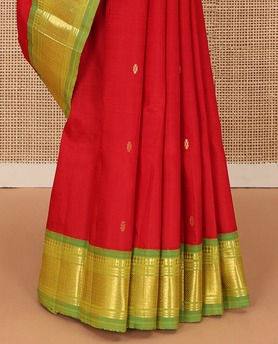 Red zari buttas Kanchipuram silk saree, contrast one-sided korvai border of panner sombu, muthu, banaras, and mayil kann, and zari design pallu