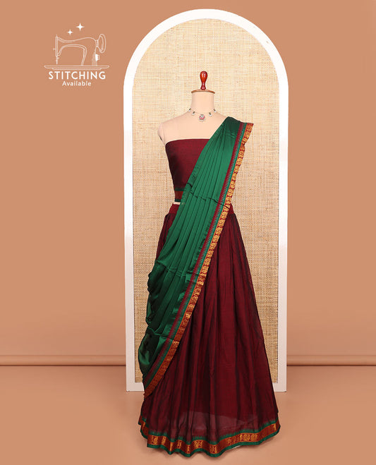 Maroon plain cotton half-saree with peacock bordered skirt, matching blouse, and a contrast peacock bordered dhavani