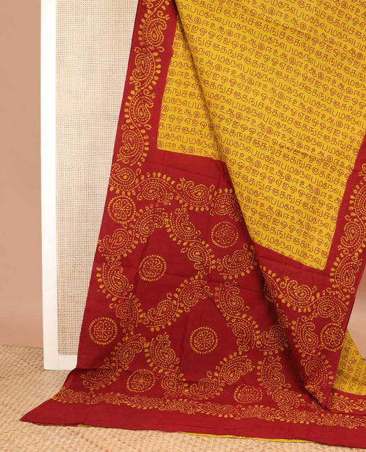 Yellow Tamil letters printed sungudi cotton saree, contrast batik printed border, and batik printed pallu