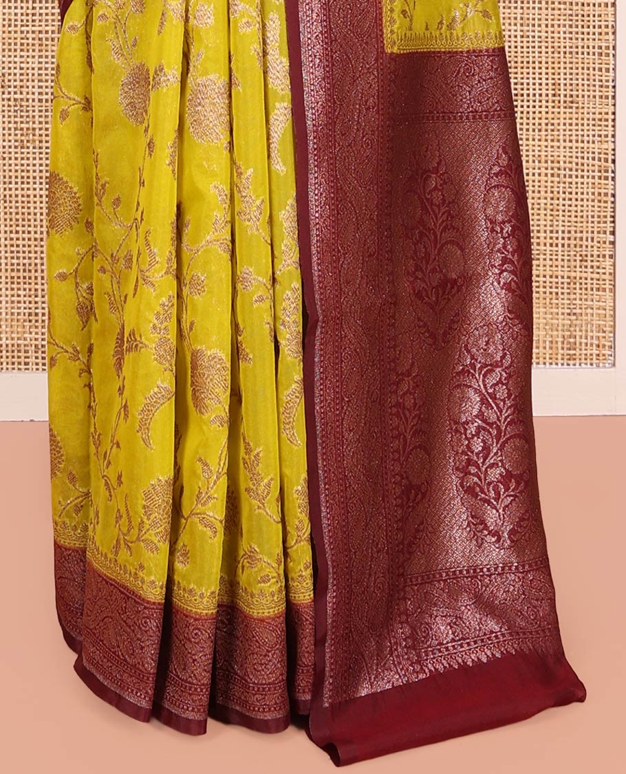 Yellow Dola Silk Saree, Artfully Detailed with Floral Jaal Design on Its Body, Complemented by Contrast Paisley Design Border, Intricately Designed Pallu, and Paired with a Contrast Blouse