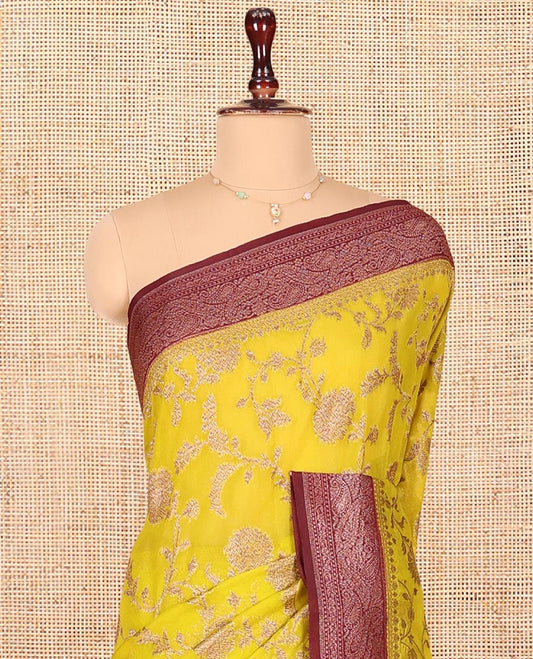 Yellow Dola Silk Saree, Artfully Detailed with Floral Jaal Design on Its Body, Complemented by Contrast Paisley Design Border, Intricately Designed Pallu, and Paired with a Contrast Blouse