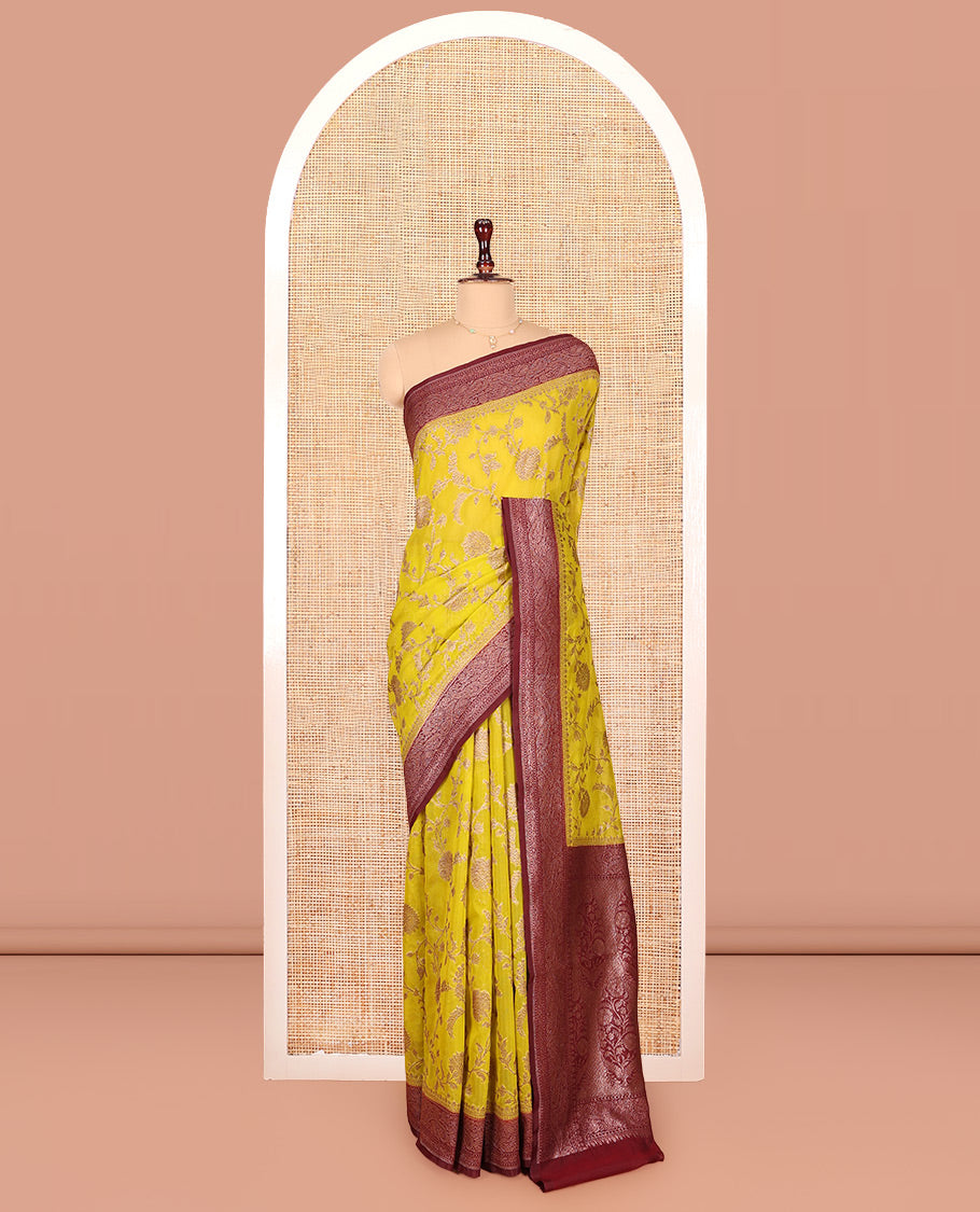 Yellow Dola Silk Saree, Artfully Detailed with Floral Jaal Design on Its Body, Complemented by Contrast Paisley Design Border, Intricately Designed Pallu, and Paired with a Contrast Blouse