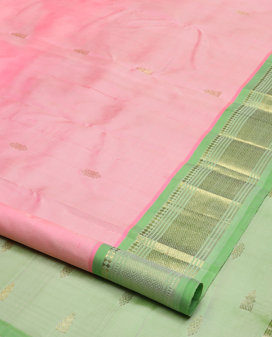 Pink zari buttas Kanchipuram silk saree, contrast one-sided border of paneer sombu, banaras, muthu, and jaal design, and zari woven pallu