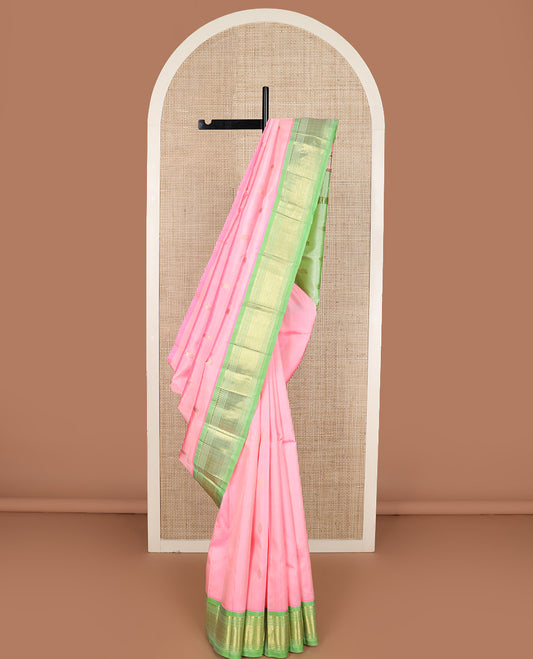 Pink zari buttas Kanchipuram silk saree, contrast one-sided border of paneer sombu, banaras, muthu, and jaal design, and zari woven pallu
