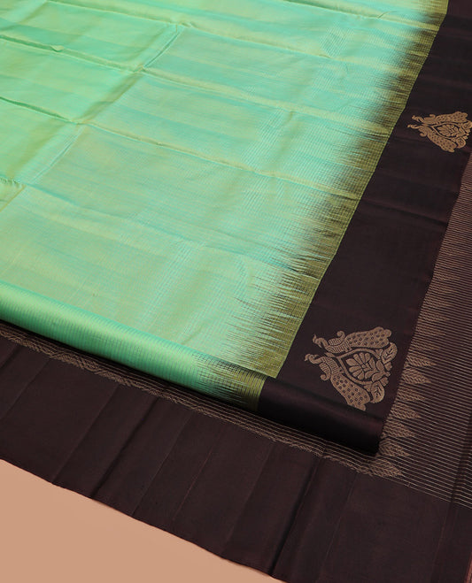Turquoise Kanchipuram Silk Saree, Subtly Sparkled with Zari Checks on Its Body, Complemented by a Contrast Border of Mayil Designs, Pallu Beautified with Jaal Design, and Paired with a Contrast Blouse
