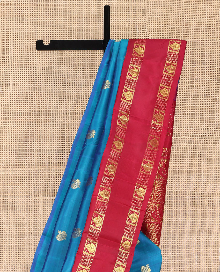 Blue Kanchipuram Silk Saree, Decked Up with Mayil Buttas on Its Body, Complemented by Contrast One-Sided Korvai Traditional Zari Border, Pallu Features Jaal and Mayil Designs, and Comes Without a Blouse