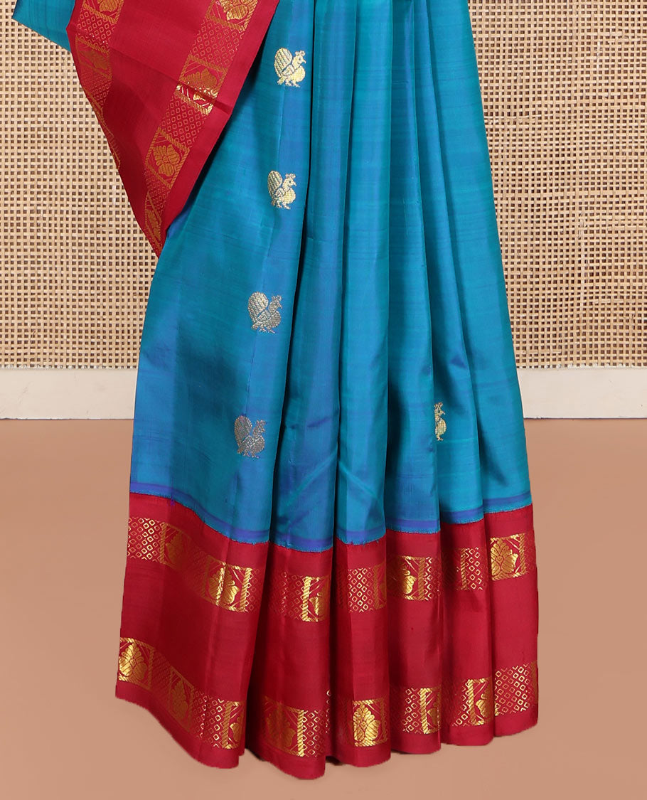 Blue Kanchipuram Silk Saree, Decked Up with Mayil Buttas on Its Body, Complemented by Contrast One-Sided Korvai Traditional Zari Border, Pallu Features Jaal and Mayil Designs, and Comes Without a Blouse