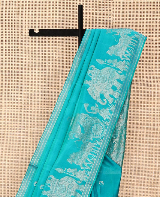 Blue Mayuri Soft Silk Saree, Richly Detailed with Ring Buttas All Over Its Body, Highlighted by a Zari Border of Wedding-Style Bride and Groom Motifs Weave, Sparsely Woven Pallu with Wedding-Related Motifs, and Paired with a Matching Blouse