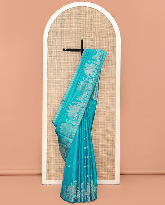 Blue Mayuri Soft Silk Saree, Richly Detailed with Ring Buttas All Over Its Body, Highlighted by a Zari Border of Wedding-Style Bride and Groom Motifs Weave, Sparsely Woven Pallu with Wedding-Related Motifs, and Paired with a Matching Blouse