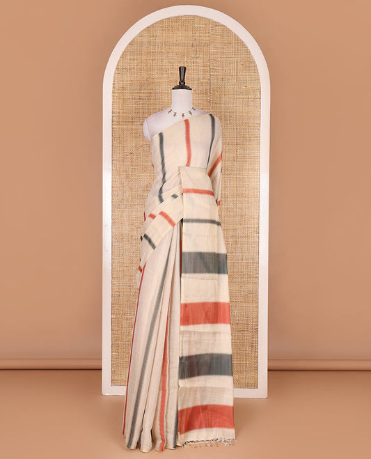 Borderless cream, colorful striped tissue saree, unique motifs printed orange color blouse