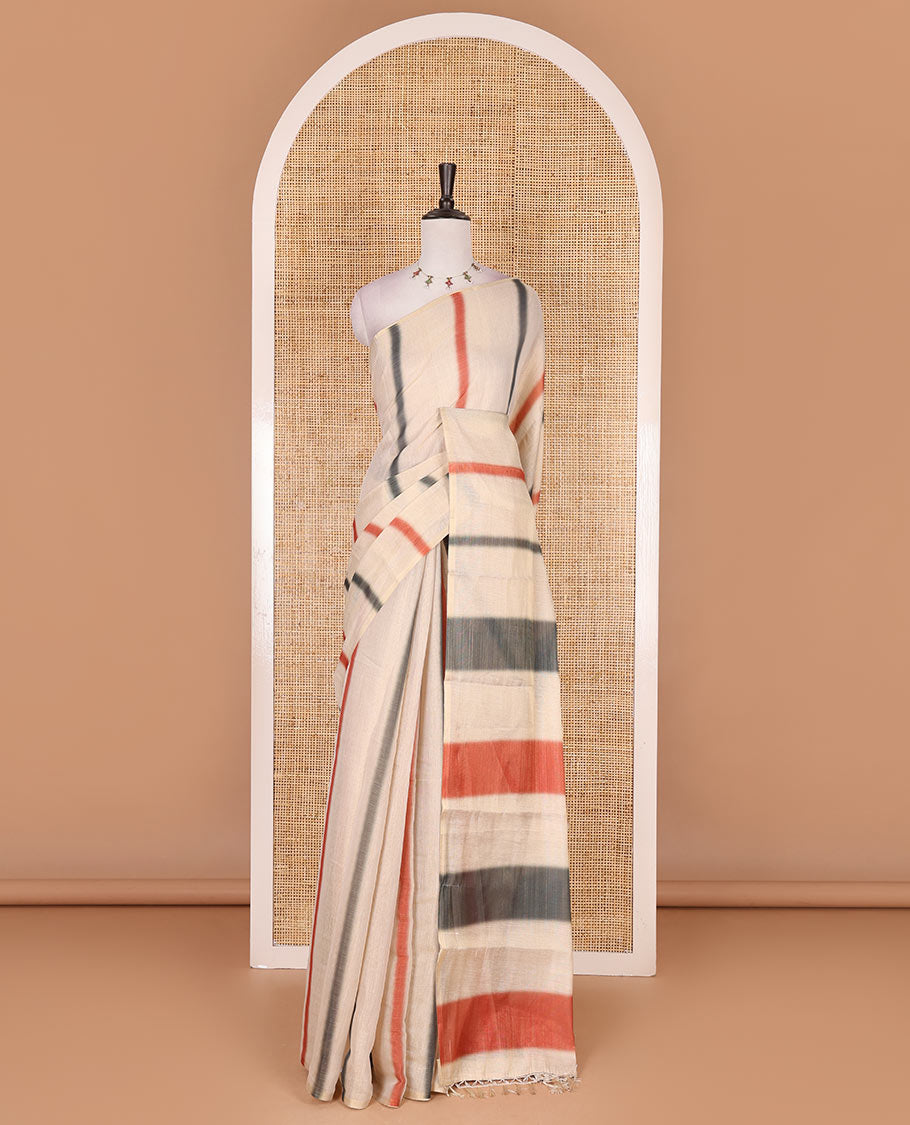 Borderless cream, colorful striped tissue saree, unique motifs printed orange color blouse