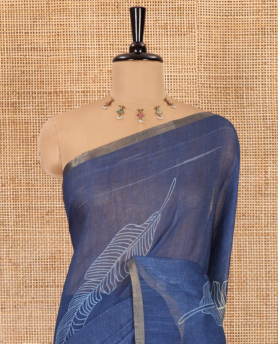 Indigo big feather motifs printed linen cotton saree, piping border, feather motifs printed pallu, and a contrast feather motifs printed blouse