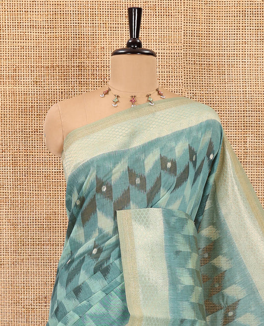 Rama zig-zag style ikkat design with buttas Munga cotton saree, zari jacquard blouse, ogee patterned pallu, and a contrast border of thread and zari buttas