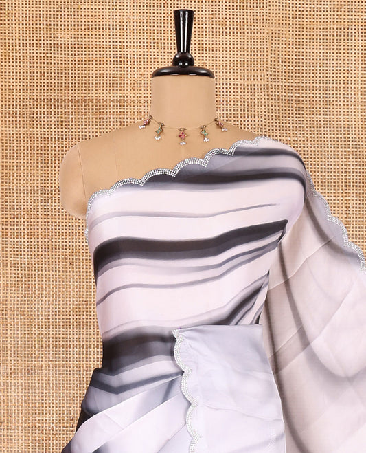 Black and white abstract printed satin crepe saree, scallop jarkan stone work border, self-pallu, and a contrast abstract printed blouse