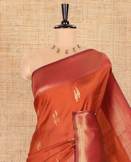 Rust Orange Kanchi Silk Saree Adorned with Pine Tree-Style Buttas Woven All Over Its Body, Complemented by Contrast Traditional Zari Design Border, Pallu Artfully Woven with Traditional Zari Designs, and Paired with a Contrast Blouse