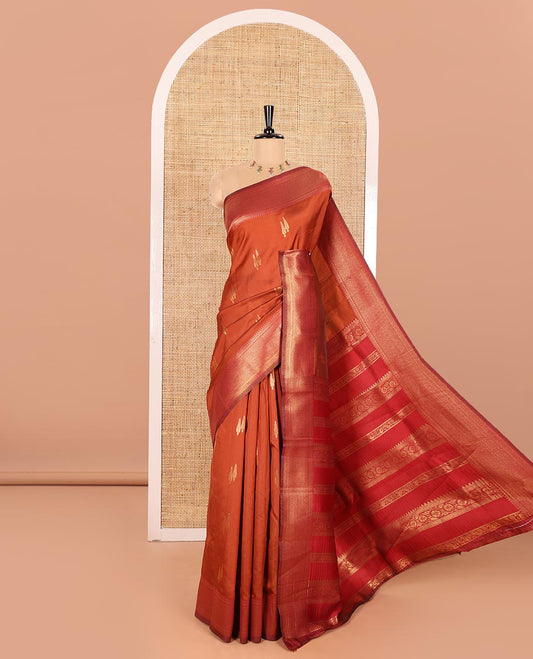 Rust Orange Kanchi Silk Saree Adorned with Pine Tree-Style Buttas Woven All Over Its Body, Complemented by Contrast Traditional Zari Design Border, Pallu Artfully Woven with Traditional Zari Designs, and Paired with a Contrast Blouse