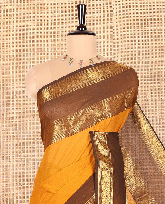 Mustard Plain Chettinad Cotton Saree, Complemented by Contrast Rettai Pettu Traditional Zari Temple Border of Peacocks, Subtly Striped Pallu, and Paired with a Matching Blouse