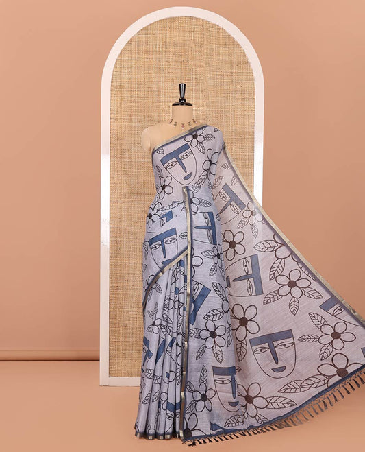 Grey Linen Cotton Saree, Depicts Flowers and Faces Printed on Its Body, Subtle Zari Piping Border, Pallu Mirrors the Self-Print, and Comes with a Contrast Blouse