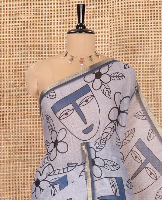 Grey Linen Cotton Saree, Depicts Flowers and Faces Printed on Its Body, Subtle Zari Piping Border, Pallu Mirrors the Self-Print, and Comes with a Contrast Blouse