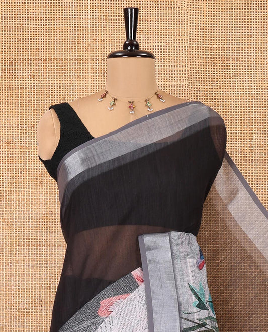 White and Black Linen Cotton Saree, Creatively Designed with Tropical Floral, and Newspaper-Texture Printed on Its Body, Complemented by a Silver Tissue Border, a Self-Printed Pallu, and Paired with a Matching Blouse