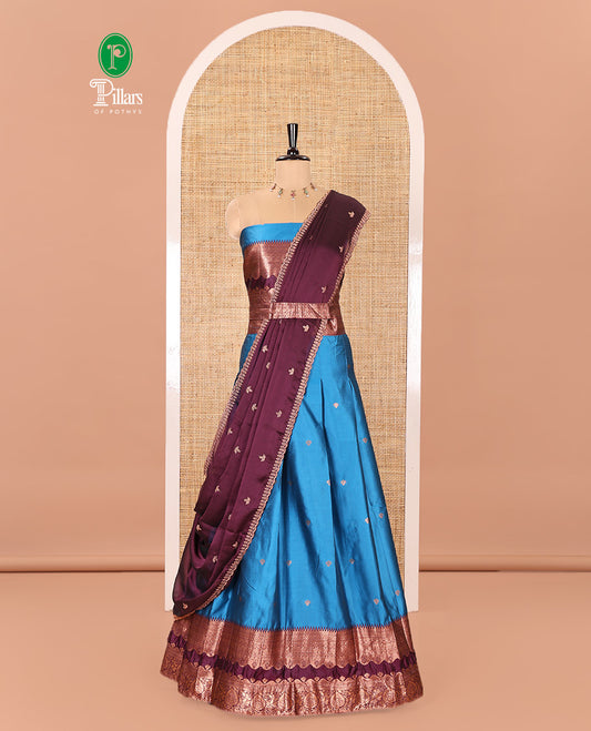 Blue-Purple Semi-Banarasi Half-Saree Mesmerized with Zari Buttas on Its Skirt, Complemented by a Contrast Traditional Zari Temple Rettai Pettu Border, Paired with a Matching Blouse, and a Satin Georgette Embroidered Scallop Dhavani