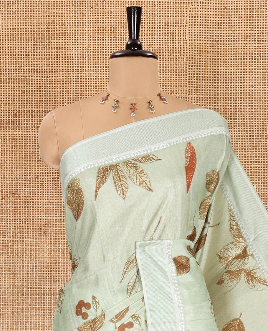 Pista green unique size and shaped leaf motifs printed fancy tussar saree, resham thread woven border, leaf motifs printed pallu, and a matching striped blouse