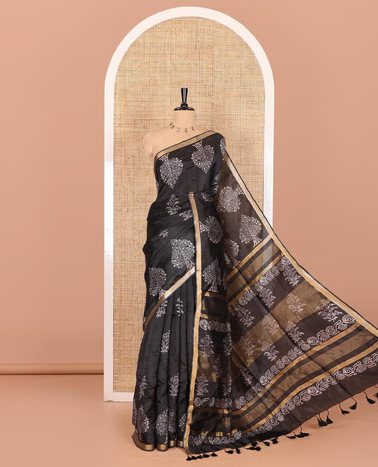 Black tree motifs discharge printed banana pith saree, zari piping border, floral printed pallu, and a tree discharge printed blouse