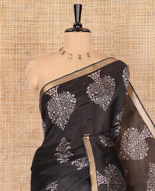 Black tree motifs discharge printed banana pith saree, zari piping border, floral printed pallu, and a tree discharge printed blouse
