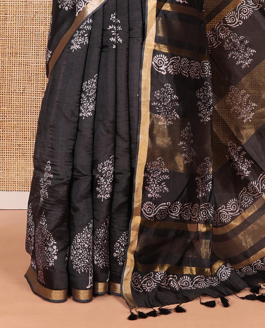 Black tree motifs discharge printed banana pith saree, zari piping border, floral printed pallu, and a tree discharge printed blouse