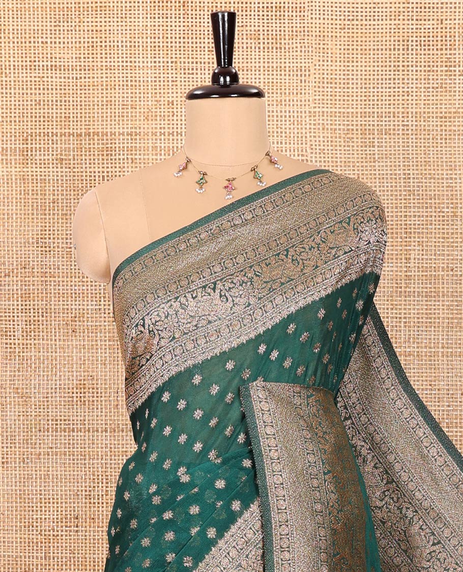 Green Semi-Banaras Khaddi Georgette, Finely Detailed with Zari Buttas All Over Its Body,  Subtly Sparkled Traditional Border of Rudraksham, Elephant, and Floral Vine Designs, Pallu of a Herd of Elephants, and Paired with a Matching Blouse