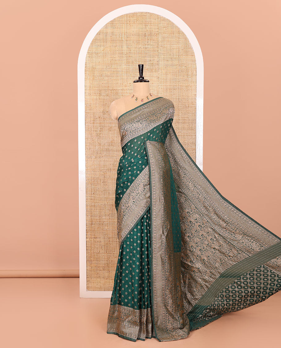 Green Semi-Banaras Khaddi Georgette, Finely Detailed with Zari Buttas All Over Its Body,  Subtly Sparkled Traditional Border of Rudraksham, Elephant, and Floral Vine Designs, Pallu of a Herd of Elephants, and Paired with a Matching Blouse