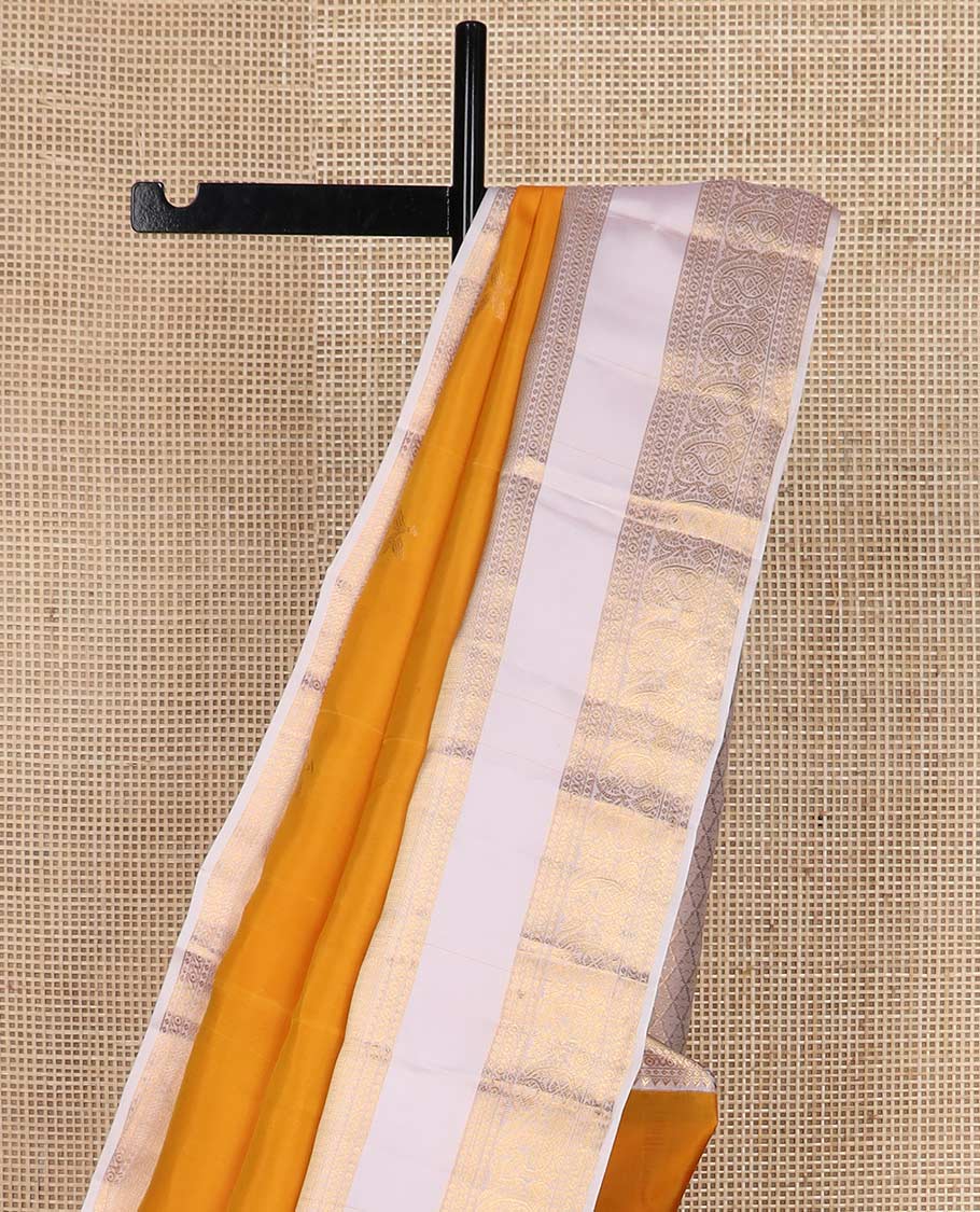 Orange zari buttas Vasundhara silk mix saree, contrast rettai pettu border of rekku, cross kamalam, and manga designs