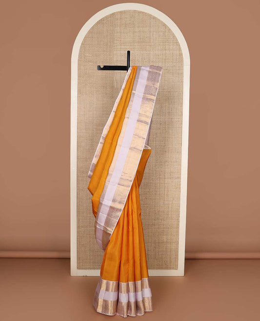 Orange zari buttas Vasundhara silk mix saree, contrast rettai pettu border of rekku, cross kamalam, and manga designs