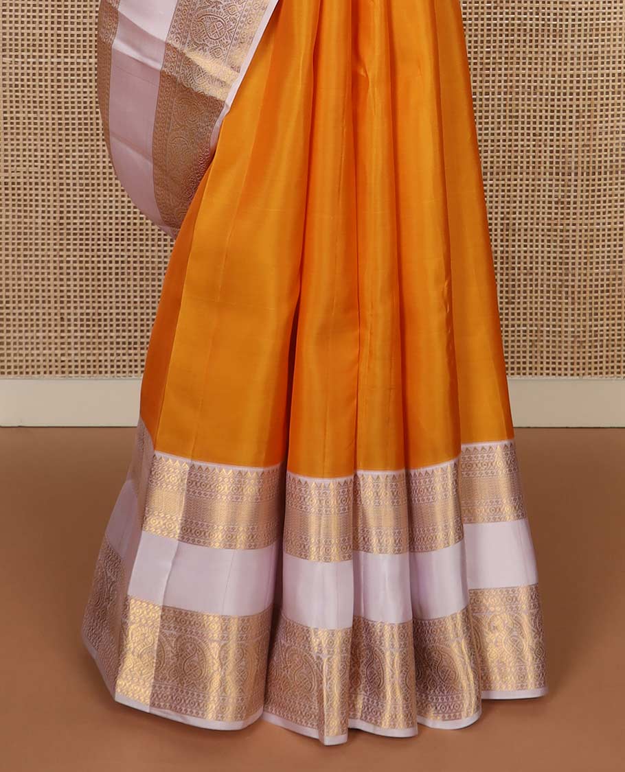 Orange zari buttas Vasundhara silk mix saree, contrast rettai pettu border of rekku, cross kamalam, and manga designs