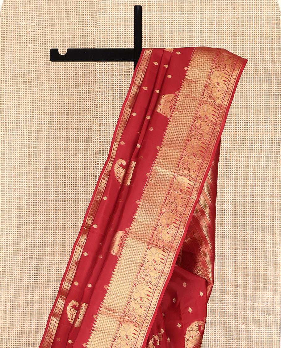 Red Vasundhara Lite Silk Mix Saree, Ornamented with Manga Zari Buttas on Its Body, Highlighted by a Zari Border of Rekku, Yaanai, and Rudraksham Designs, Pallu of Diagonal Designs, and Paired with a Matching Blouse