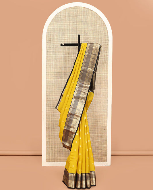 Yellow Vasundhara Lite Silk Mix Saree, Sparsely Woven with Zari Buttas on Its Body, Complemented by a Contrast Border of Manga, Muthu, Kamalam, Banaras, Diamond, and Mayil Designs, Pallu of Leaf Vine Designs, and Paired with a Contrast Blouse