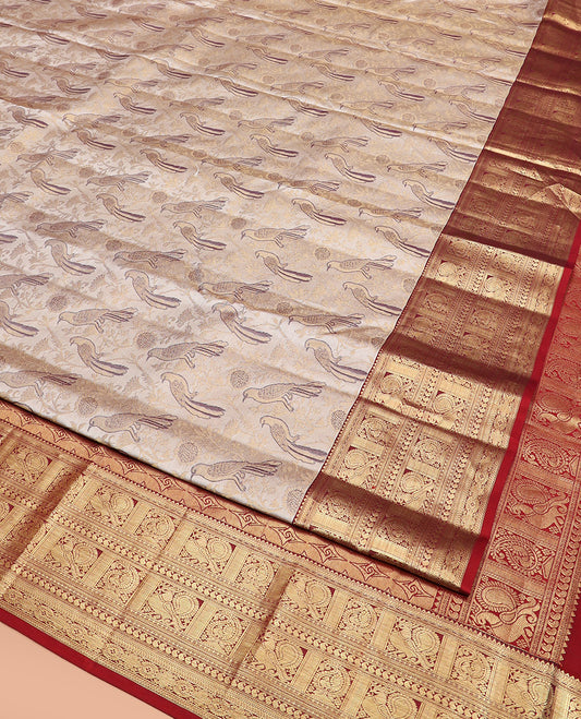 Cream Kanchipuram Silk Saree Artfully Woven with Bird Jacquard Design, Complemented by Contrast Border of Rekku, Mayil, Arumbu Manga, and Chakram Designs, Elegantly Highlighted Pallu of Geometric Patterns, and Paired with a Contrast Blouse