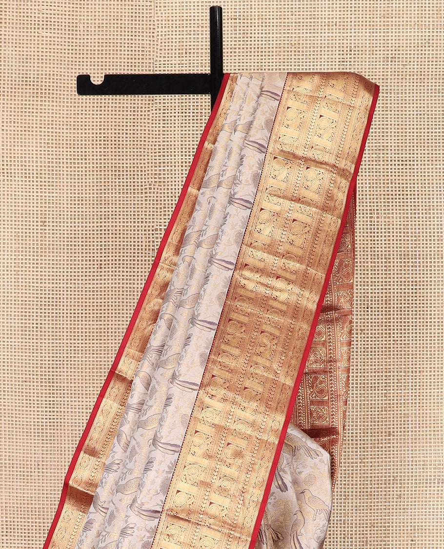 Cream Kanchipuram Silk Saree Artfully Woven with Bird Jacquard Design, Complemented by Contrast Border of Rekku, Mayil, Arumbu Manga, and Chakram Designs, Elegantly Highlighted Pallu of Geometric Patterns, and Paired with a Contrast Blouse