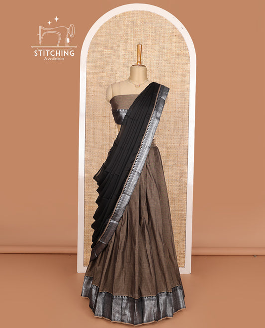 Brown cotton half-saree, plain with contrast traditional design steeped border skirt, matching blouse, and contrast bordered dhavani