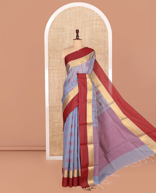 Grey Semi-Silk Cotton Saree, Sparsely Threaded with Buttas and Stripes All Over Its Body, Complemented by a Contrast Border of Traditional Zari Designs, Pallu of Jaal Designs, and Paired with a Matching Blouse