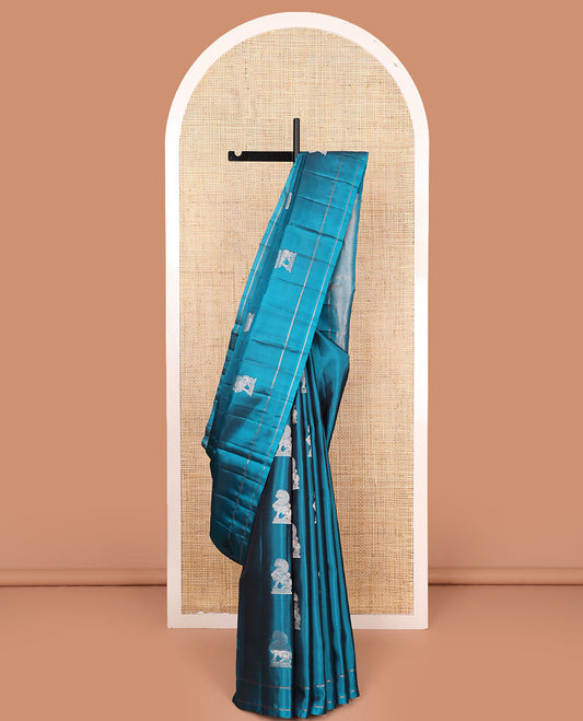 Blue singam buttas soft silk saree, zari striped border, and pallu of vanki designs