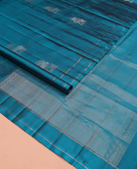 Blue singam buttas soft silk saree, zari striped border, and pallu of vanki designs