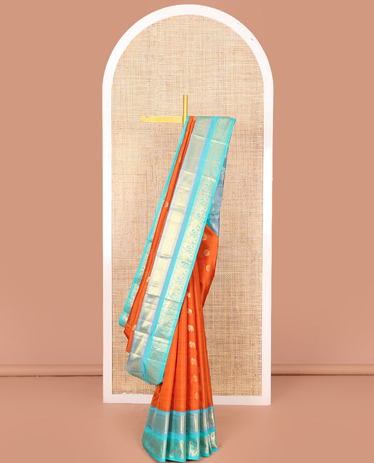 Orange Vasundhara Silk Saree Embellished with Yaanai and Poun Buttas All Over Its Body, Complemented by Zari Border of Neli, Mayil Kann, and Yaanai Designs, a Grand Pallu of Jaal Designs, and Paired with a Contrast Blouse